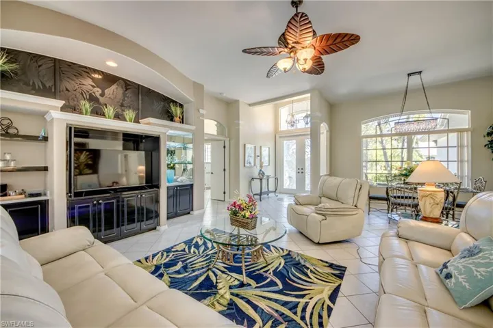 Living room featuring ceiling fan and light tile floors