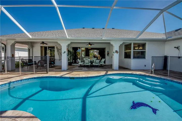 View of swimming pool with a patio area, a lanai, and ceiling fan