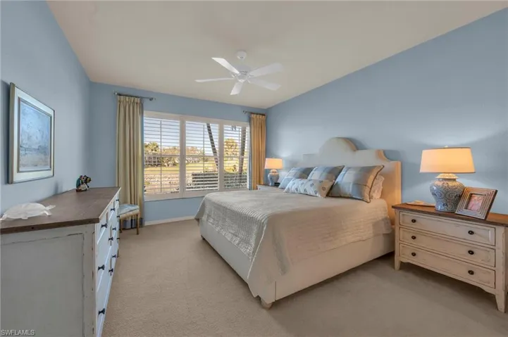 Bedroom featuring light colored carpet and ceiling fan