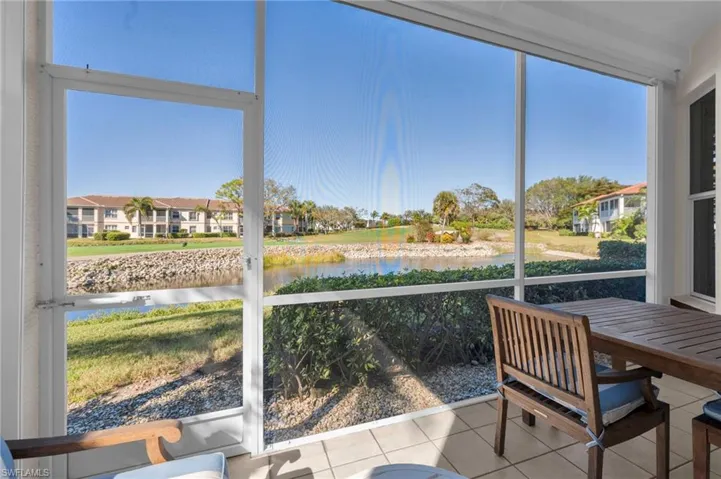 Screened Lanai with a water, golf and founatain view and tile patterned flooring