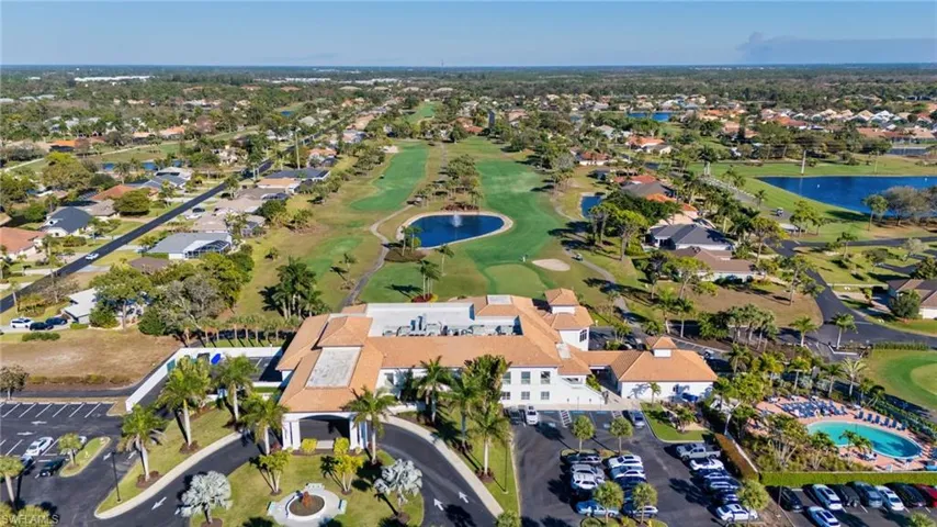 Aerial view of property's location with a large body of water and nearby suburban area