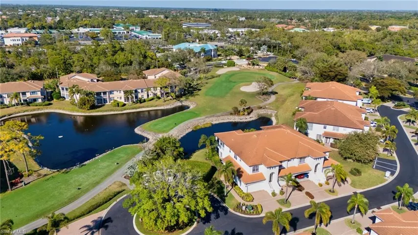 Aerial overview of property's location featuring a nearby body of water, a golf club, and nearby suburban area