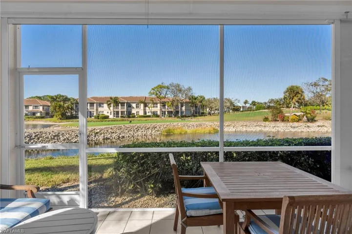 Screened Lanai featuring a water view and tile patterned flooring