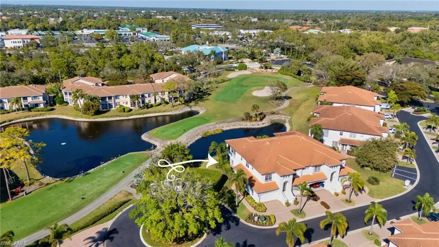 View of property location with a large body of water, a local golf course, and nearby suburban area