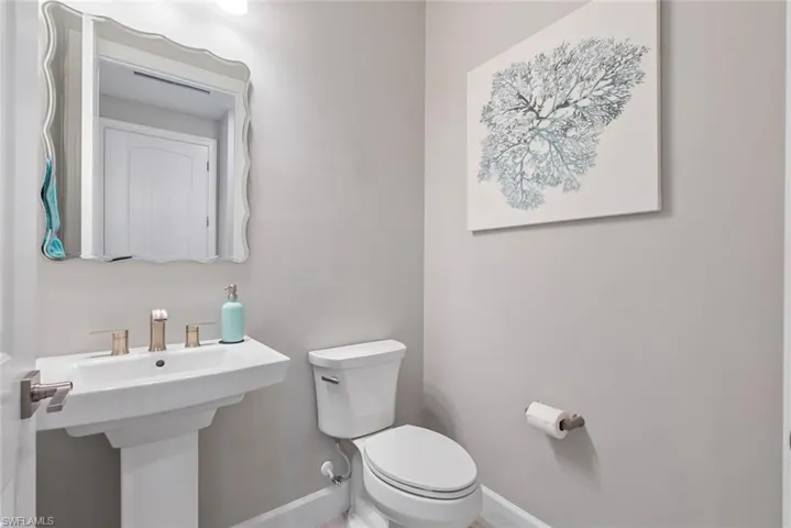 Bathroom featuring toilet and baseboards