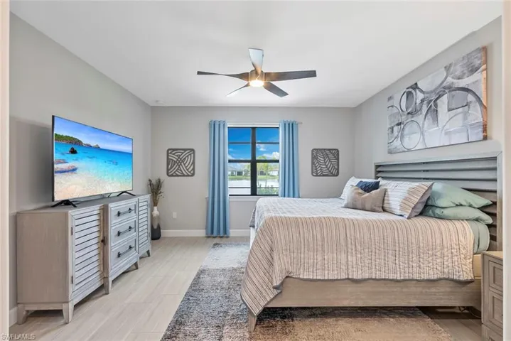 Bedroom with baseboards and a ceiling fan