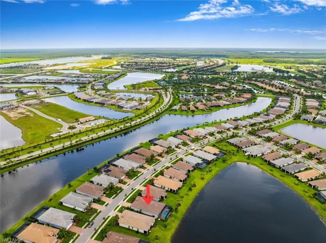 Aerial perspective of suburban area featuring a large body of water