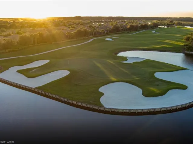 Aerial view at dusk of a water view and golf course view