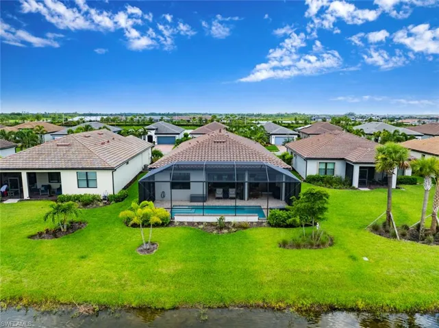 Aerial view of residential area featuring a nearby body of water