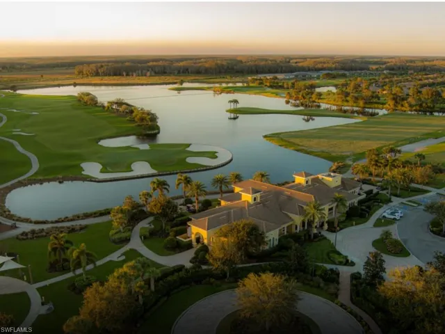 Aerial perspective of suburban area featuring a large body of water and a local golf course