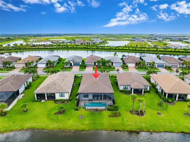 Aerial view of residential area featuring a large body of water