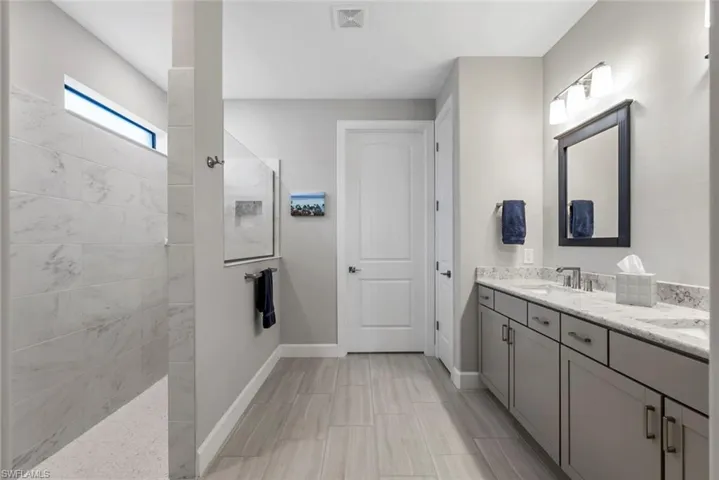 Full bathroom featuring walk in shower and vanity
