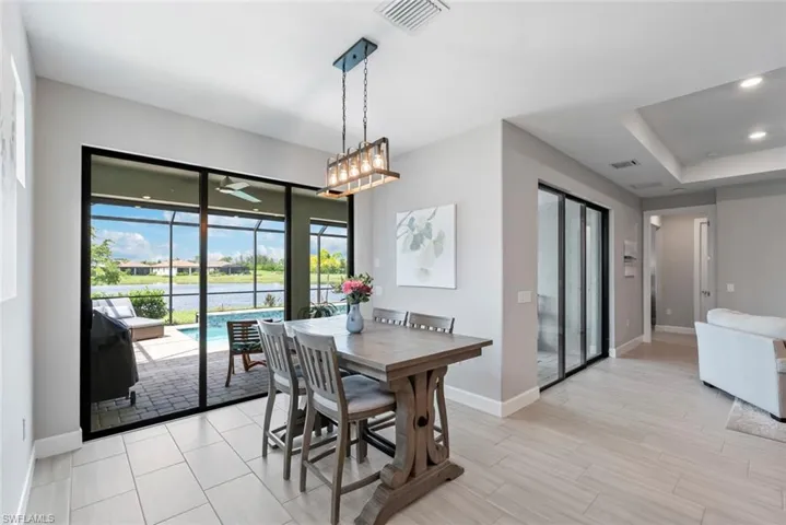 Dining area featuring ceiling fan, recessed lighting, and a tray ceiling