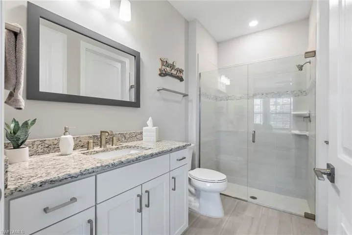 Full bath with vanity and a stall shower