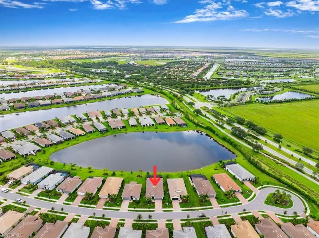 Aerial view of residential area featuring a nearby body of water
