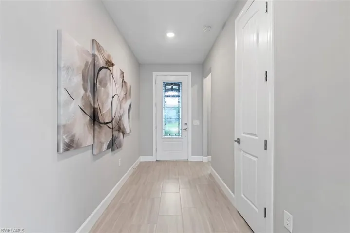 Entryway featuring baseboards and recessed lighting