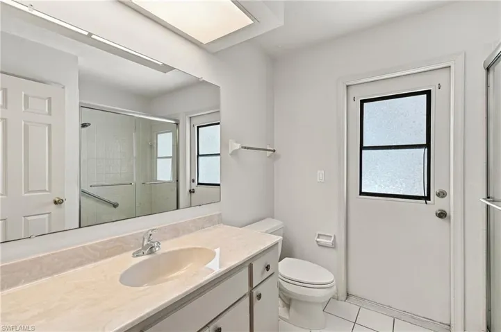 Vanity with an integrated sink and light-toned countertop