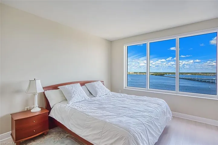 Bedroom featuring baseboards and a water view