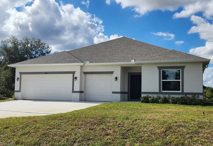 View of front of home featuring a front lawn, stucco siding, a garage, concrete driveway, and a shingled roof