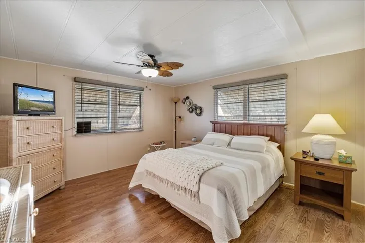 Bedroom with ceiling fan and wood finished floors
