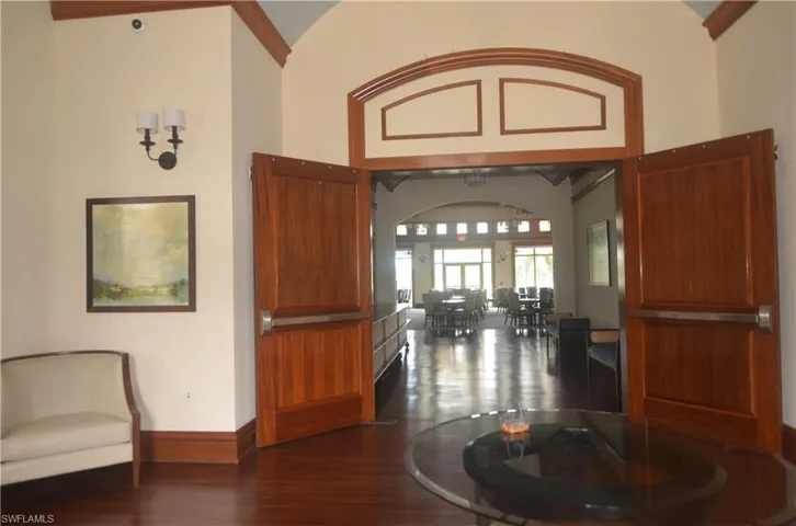 Entrance foyer featuring arched walkways and dark wood-style flooring