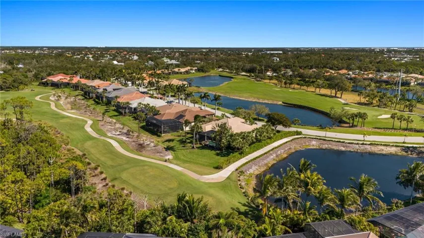 Aerial view with golf course view and a water view