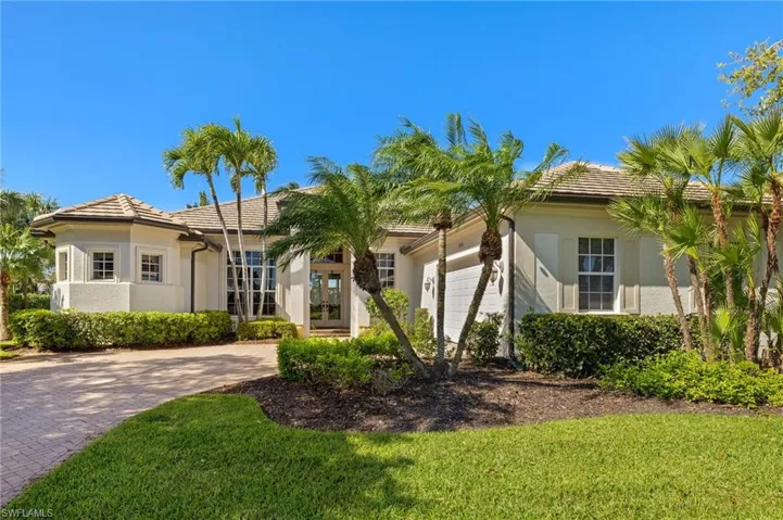 Mediterranean / spanish house with an attached garage, stucco siding, decorative driveway, and french doors