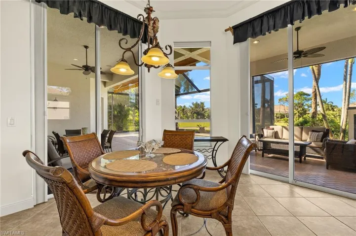 Dining area with ceiling fan, light tile patterned flooring, a sunroom, and a healthy amount of sunlight