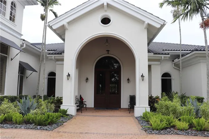 Entrance to property featuring stucco siding, a porch, and a tile roof