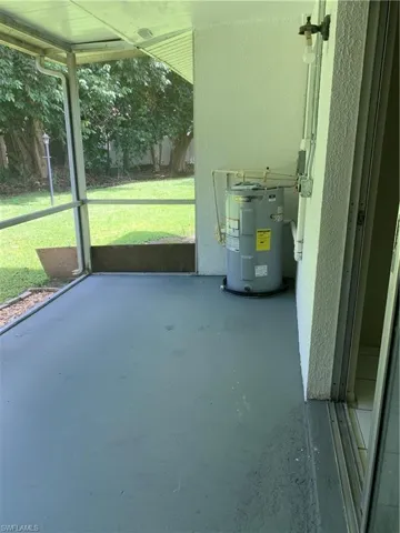 Unfurnished sunroom featuring water heater