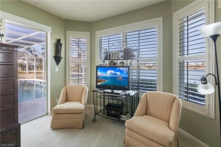 Living area featuring light carpet