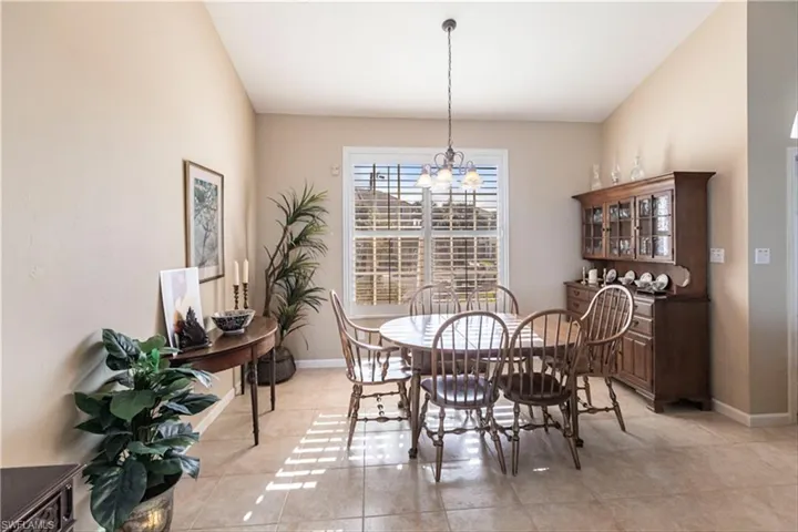 Tiled dining area featuring a notable chandelier