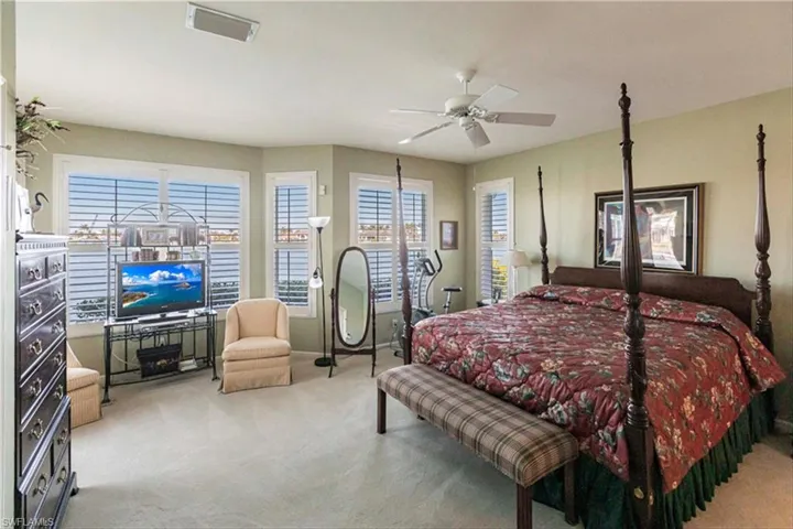 Bedroom with light carpet and ceiling fan