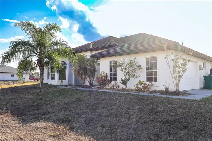 Ranch-style house with an attached garage and stucco siding