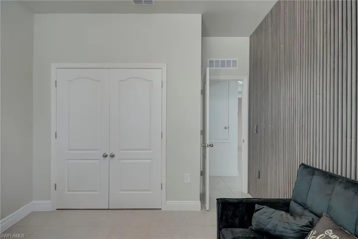 Living area featuring light tile patterned floors and baseboards