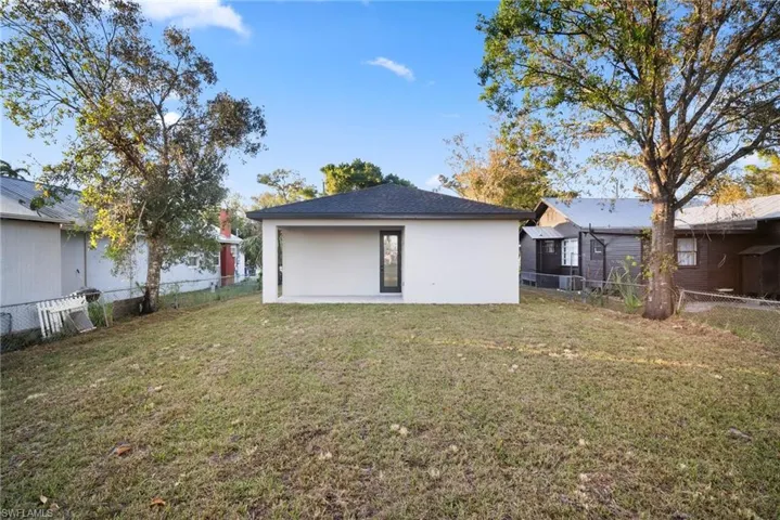 Rear view of house featuring a lawn