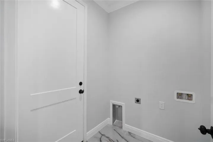Laundry room featuring hookup for an electric dryer and hookup for a washing machine