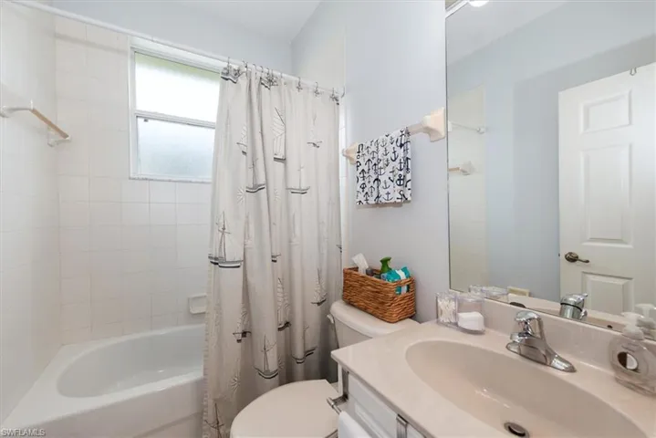 Bathroom featuring shower / tub combo and vanity