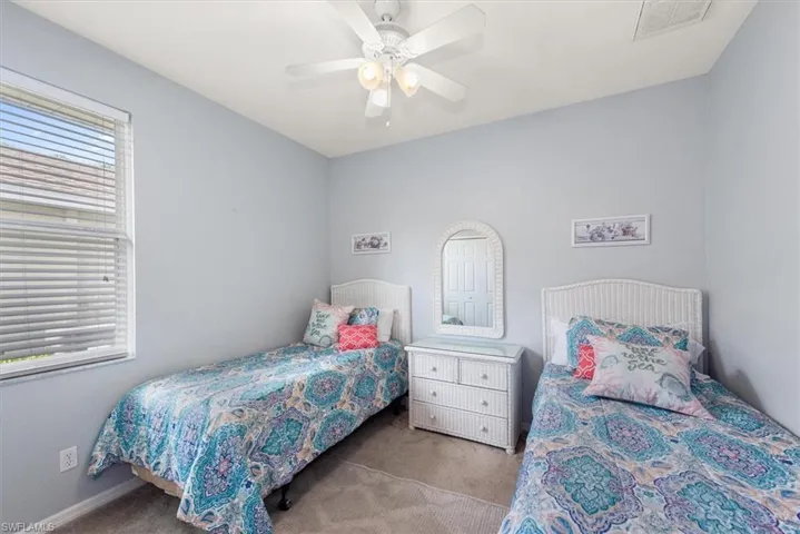 Carpeted bedroom with ceiling fan