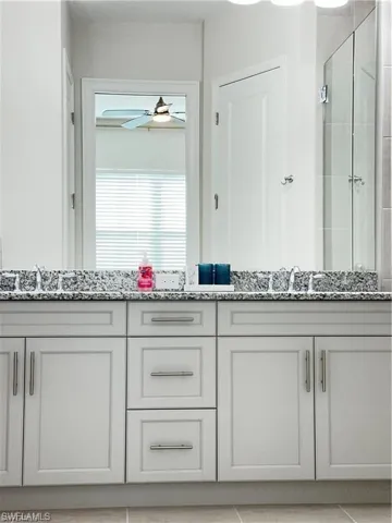 Bathroom with double vanity and a shower stall