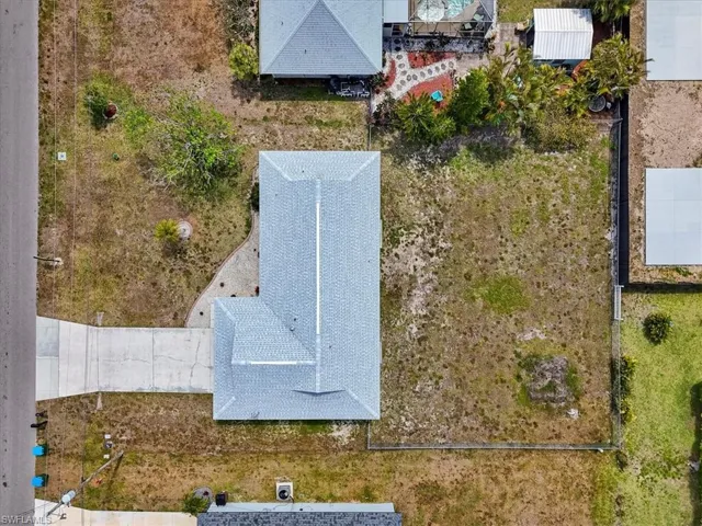 Drone / aerial view with large fenced backyard, room for a pool