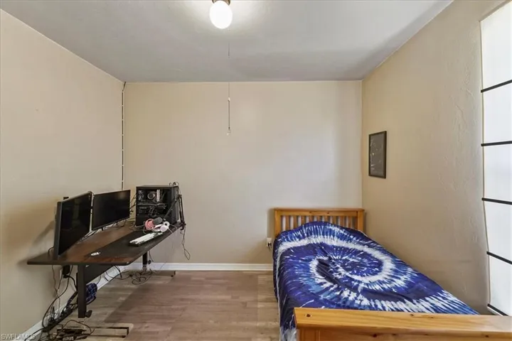 Bedroom with  wood look finished floors