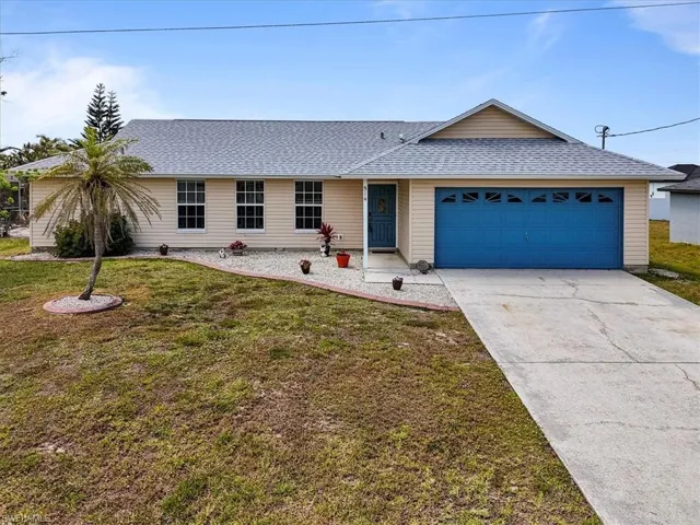 Ranch-style house featuring a garage, concrete driveway, a shingled roof, and a front lawn