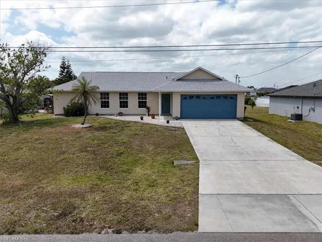 Ranch-style home with driveway, a garage, a front lawn, and new shingle roof