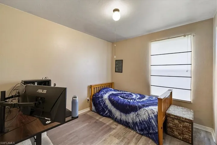 Bedroom featuring baseboards and wood look finished floors