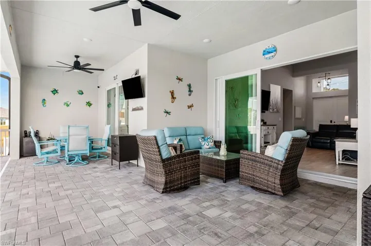 View of patio / terrace with outdoor dining space, an outdoor living space, and a ceiling fan