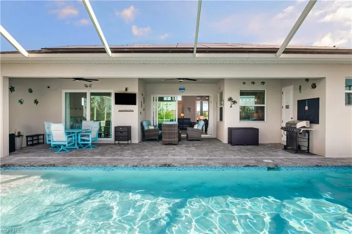 Rear view of house with a patio, a lanai, a ceiling fan, and stucco siding