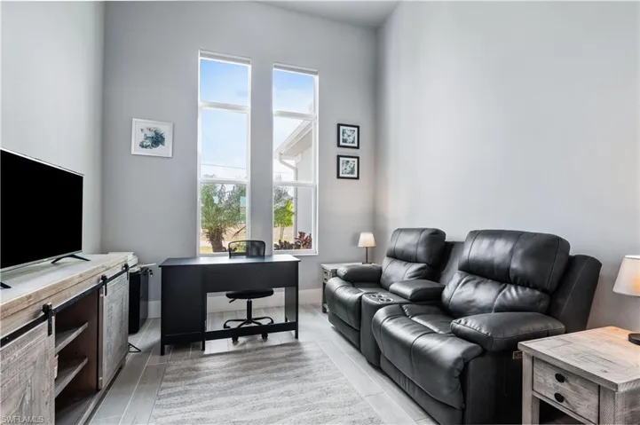 Home office with a healthy amount of sunlight, wood tiled floor, and baseboards