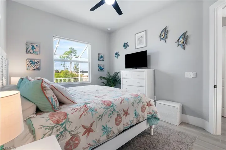 Bedroom featuring ceiling fan and baseboards