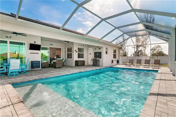 View of swimming pool with a fenced in pool, a patio, ceiling fan, an outdoor hangout area, and a lanai
